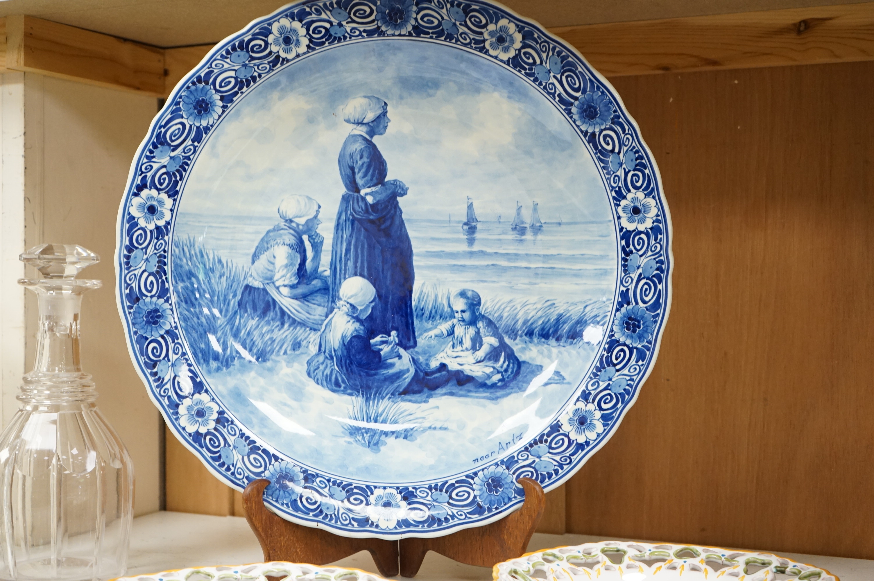 A Delft charger after Artz, together with other faience and majolica dishes, largest 41cm diameter (6)